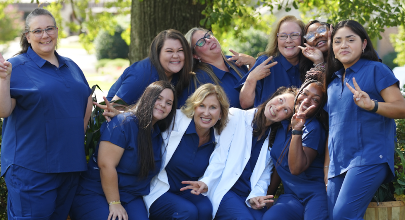 Karen Park Family Dentistry staff making silly faces outside with a tree behind